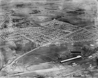 Carntyne Housing Estate and Carntyne Greyhound Racecourse, Glasgow.  Oblique aerial photograph taken facing north-east.