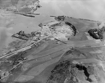 Oblique aerial photograph taken facing east showing Tilbury Contracting and Dredging Co. Ltd. Quarry and Thomas Ward and Sons Shipbreaking Yard, Inverkeithing and a golf course in 1931.