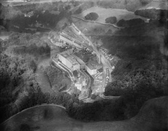 New Lanark, general view, showing Gourock Ropework Co. Ltd. Mills and New Lanark Road.  Oblique aerial photograph taken facing north-east.