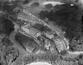 New Lanark, general view, showing Gourock Ropework Co. Ltd. Mills and New Lanark Road.  Oblique aerial photograph taken facing north.