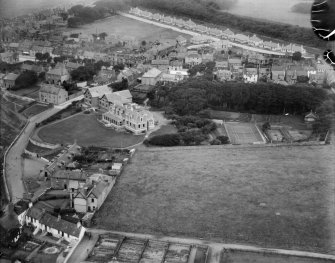 Elie, general view, showing The Toft and Woodside Road.  Oblique aerial photograph taken facing north.  This image has been produced from a damaged negative.