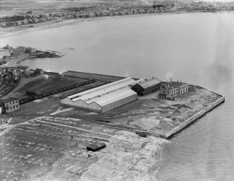 Former Ardrossan Dry Dock and Shipbuilding Co. Inches Yard and South Bay, Ardrossan.  Oblique aerial photograph taken facing east.