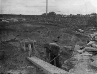 Excavation photograph: Workmen removing sand overburden.