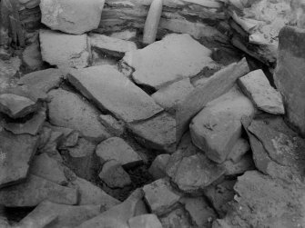 Excavation photograph: House 2, detail of tumbled stones filling N. W. corner of house, door jamb visible top left.
Copy negative 1995. Original print in Print Room.