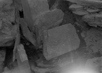 Excavation photograph: House 2, detail of tumbled stones in S. W. corner; Deliberate blocking of passage adjoining house 1 visible top.