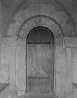 S porch, inner end, detail of Romanesque doorway with nookshafts and cushion capitals.