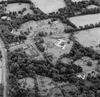 Oblique aerial view centred on the hospital before development and house, taken from the W.