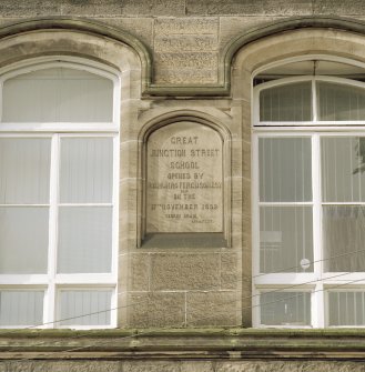 Detail of panel on NE wall of rear block with inscription "GREAT JUNCTION STREET SCHOOL Opened By R.C. Munro Ferguson Esqr. M.P. on the 17th November 1892. George Craig, Architect"