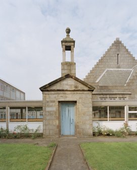 Entrance doorway and bellcote from 'Old Grammar School' now built into corridor linking main building to extensions at rear. View from E