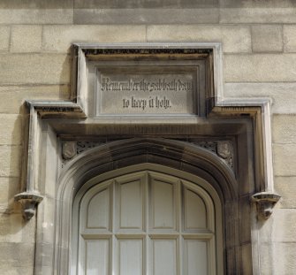Detail of carved panel above doorway on north side of courtyard
