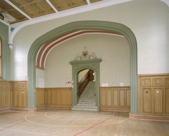 Interior, ground floor, chapel (now assembly hall), view of archway and entrance stair from north west