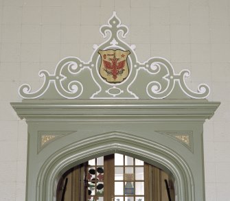 Interior, ground floor, chapel (now assembly hall), detail of pediment above doorway