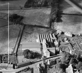 Ballantyne's Cashmere Caerlee Mills, Damside, Innerleithen.  Oblique aerial photograph taken facing west.  This image has been produced from a crop marked negative.
