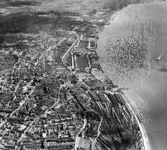 Dundee, general view, showing Dundee Station and Docks.  Oblique aerial photograph taken facing east.  This image has been produced from a damaged negative.