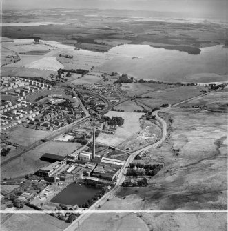 Caldercruix, general view, showing Robert Craig and Sons Ltd. Caldercruix Paper Mills, Airdrie Road and Hillend Reservoir.  Oblique aerial photograph taken facing east.  This image has been produced from a crop marked negative.