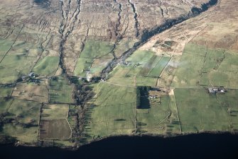 Oblique aerial view of the landscape, field systems and farmsteads on Ben Lawers Farm, to the west of the Lawers Burn, and Machuim and Duallin Farms, to the east of the burn. Taken from SE.