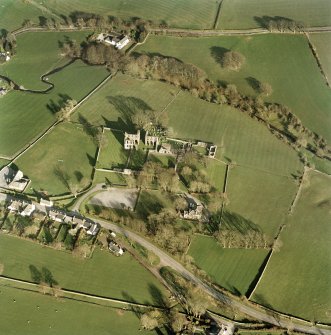 Oblique aerial view centred on the abbey and manse, taken from the west showing the former yards of the abbey.