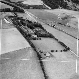 Ladysbridge Hospital and Ladysbridge Station, Boyndie.  Oblique aerial photograph taken facing east.  This image has been produced from a crop marked negative.