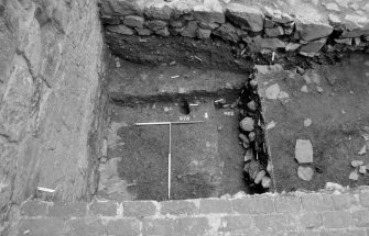 Excavation photograph : area N - posthole 978, in mixed mortar and clay 976, and slot 982 cutting 989.