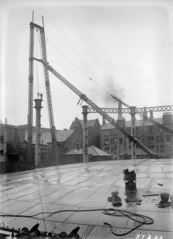 General view of dismantling of redundant columns of Number 4 gas holder, with tenement in Holyrood road visible in background,  Meadow Flat Gasholder Station, Holyrood Road, Edinburgh.