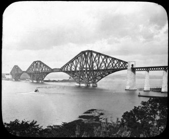 General view of the bridge from the South shore.
Insc. 'Forth bridge. G.W.W.'
Insc. on the back of the slide '281.'
Insc. on the slide but covered by the mount 'Forth Bridge, from South. 6975. G.W.W. Height 369 Ft. Length (including viaduct) 8098 Ft. Spans 1710 Ft. each.'
Lantern slide.