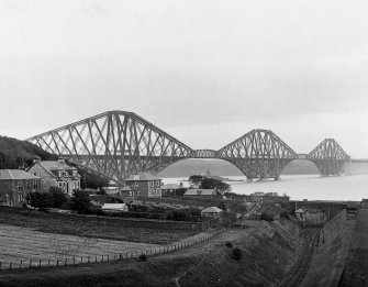 View of the bridge from the North West with houses and fields in the foreground.
Insc. 'Forth Bridge from N.W. Co. Cameron.'
Lantern slide.