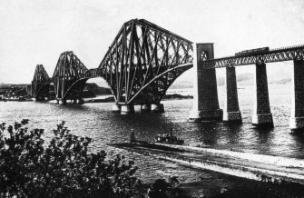 General view of the bridge in use seen from the South West.
Insc. on negative 'The Forth Bridge. Length 8296 Ft. Height 354 Ft. Spans 1700 Ft each. J. Patrick.'
Insc. on front of mount 'Forth Bridge & Hawes Pier.'
Insc. on back of mount 'T.J. Walls, Optician, 12 Forrest Road., Edinr.'
Lantern slide.