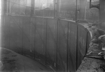 General view of tank of Number 4 Meadowflats Gas holder Station, Holyrood Road, Edinburgh, with bell removed, exposing "dumpling", and with Number 5 gas holder to South in background