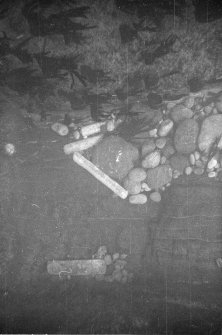 Four lead ingots lodged at the interface between the sides and fill of Gulley B. Note the short ingot lodged in a hollow of the gulley wall from where, it may be presumed, it has never moved since deposition.