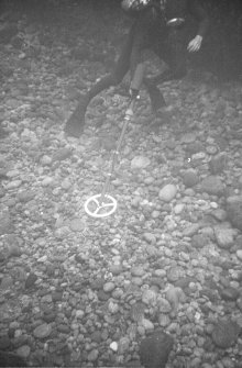The metal-detector in use over the stones in Gulley B.