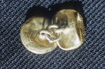 Linked gold buttons, under side. The arms of Amsterdam and the letter "B" are 			struck on the back of each button. This may be the mark of the Amsterdam silversmith Jan Breda (1668-1725).