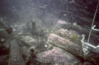 Maritime photographs: Underwater photograph of cannons in situ at the investigation of the wreck, Wrangels Palais (HU77SW 8001). 
(Received with Archaeological Diving Unit (ADU) papers).