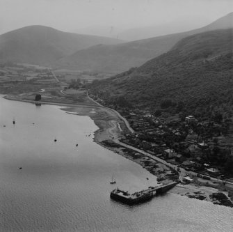 Lochranza, general view, showing Coillemore Point and Lochranza Castle, Isle of Arran.  Oblique aerial photograph taken facing south-east.  This image has been produced from a print.