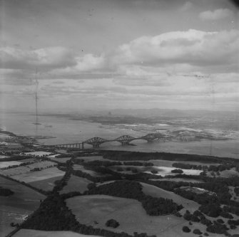 Firth of Forth, general view, showing Dalmeny Park and Forth Rail Bridge.  Oblique aerial photograph taken facing north-west.  This image has been produced from a damaged print.