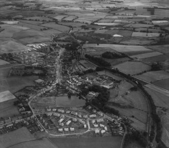 Lennoxtown, general view, showing J and W Somerville Ltd. Kali Nail Works, Station Road and Main Street.  Oblique aerial photograph taken facing south-east.  This image has been produced from a print.