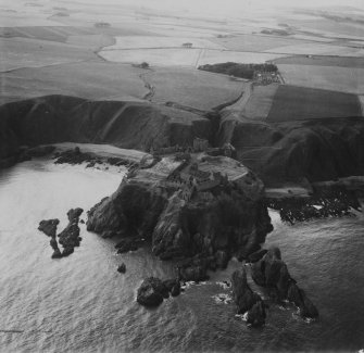 Dunnottar Castle.  Oblique aerial photograph taken facing west.  This image has been produced from a print.