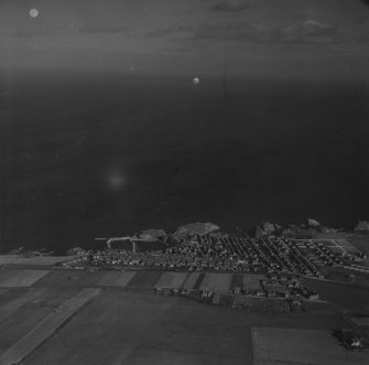 Portknockie, general view.  Oblique aerial photograph taken facing north.  This image has been produced from a print.