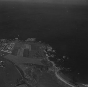 Portknockie, general view, showing Scar Nose and Toshie's Long Craigs.  Oblique aerial photograph taken facing north.  This image has been produced from a print.