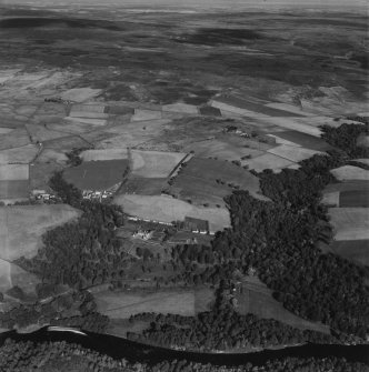 Knockando House and Estate, Knockando.  Oblique aerial photograph taken facing north.  This image has been produced from a print. 