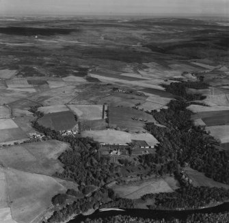 Knockando House and Estate, Knockando.  Oblique aerial photograph taken facing north.  This image has been produced from a print. 