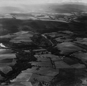 Knockando House and Estate, Knockando.  Oblique aerial photograph taken facing south.  This image has been produced from a print. 