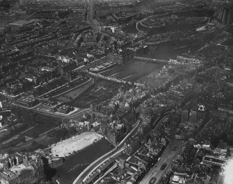 Edinburgh, general view, showing Edinburgh Castle Esplanade and Waverley Station.  Oblique aerial photograph taken facing north-east.  This image has been produced from a print.