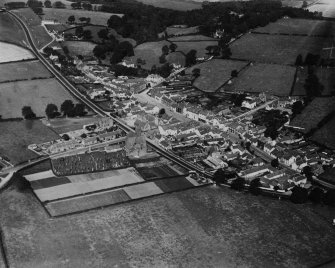 Ecclefechan, general view, showing High Street and Johnstone United Presbyterian Church.  Oblique aerial photograph taken facing north.  This image has been produced from a print.