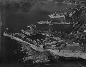 Ardrossan Harbour and Refinery.  Oblique aerial photograph taken facing north.  This image has been produced from a print.