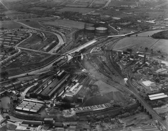 Temple and Dawsholm Gas Works, Maryhill, Glasgow.  Temple Gasholder Nos 4 and 5 are visible (top), Garscube Chemical Works and Dawsholm New Chemical Works are on the right beyond the railway sidings. Oblique aerial photograph taken facing west.  This image has been produced from a print.