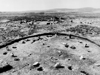 Excavation photograph. Stone circle XI in the foreground with circle I in the background, from the NE. At circle XI stone 4 (F120) is in the foreground with stone 5 (F121) lying out of position to its left. Posthole F110 (Burl's D) is between stones 4 and 5.