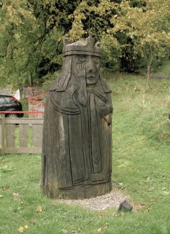 General view of wooden sculptured 'Lewis Chessman' within Lews Castle policies, Stornoway, taken from the south east.