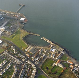 Oblique aerial view of the Cockenzie Harbour centred on the harbour with a power station adjacent, taken from the SE.