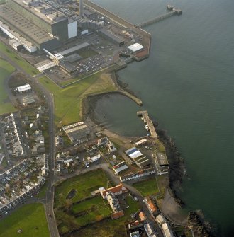 Oblique aerial view of the Cockenzie Harbour centred on the harbour with a power station adjacent, taken from the E.
