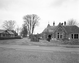 View of gate piers and lodge house.